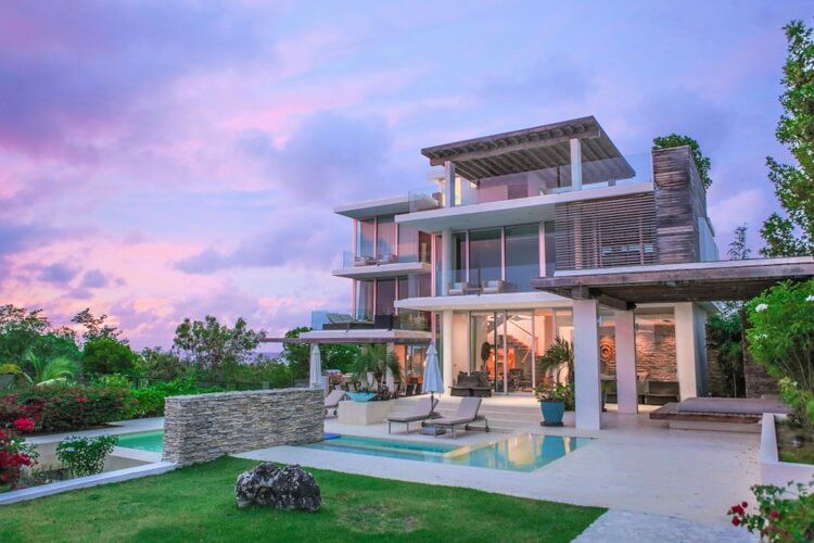 modern villa and gardens at sunset