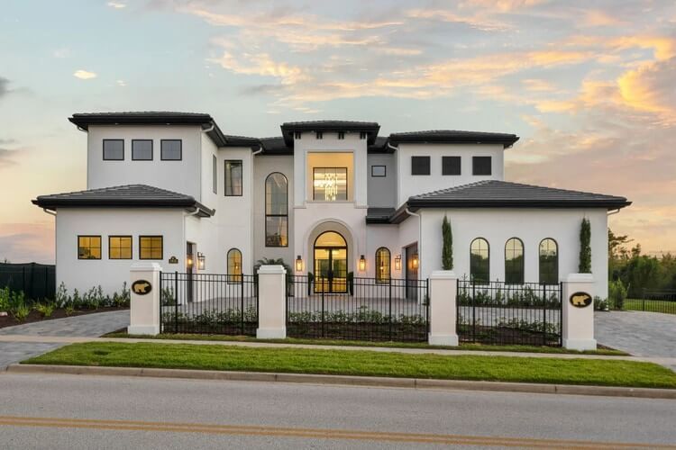 lit up white villa at dusk