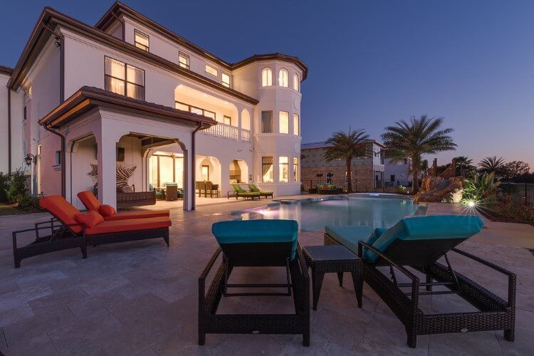 white villa pool and loungers at dusk