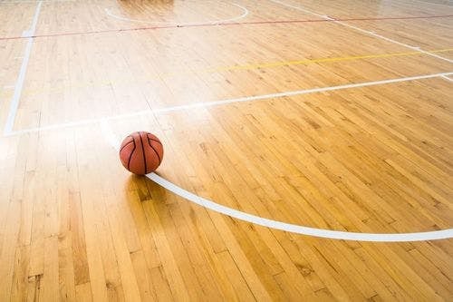 A basketball on a wooden floor