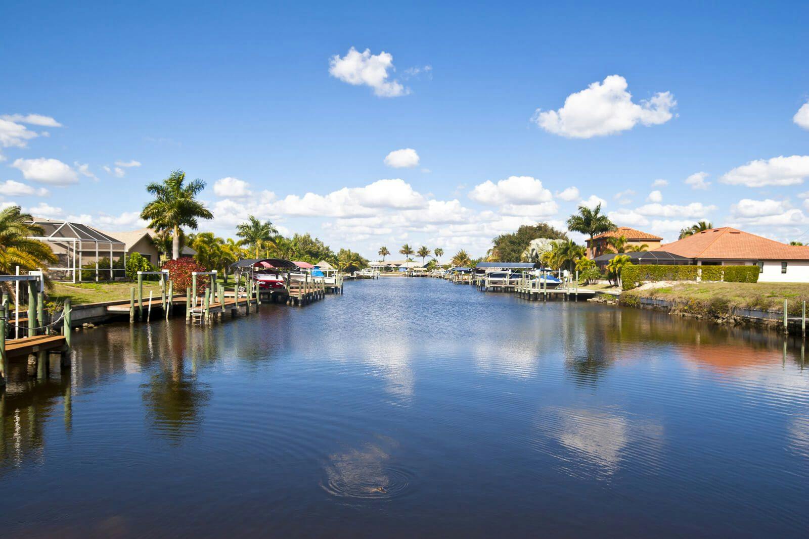 View of a canal in Cape Coral with homes lining the waterside