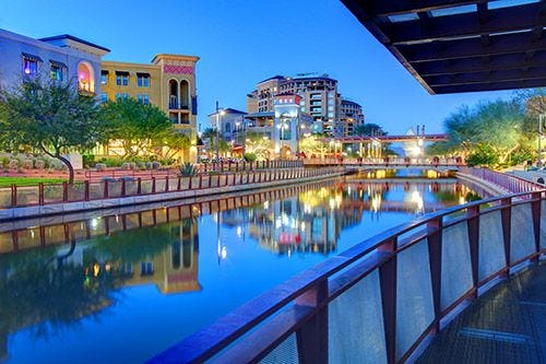 Downtown Scottsdale at twilight with the river running through the city