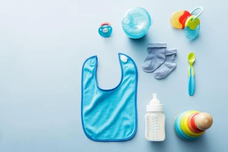 Assorted baby gear against a pale blue background