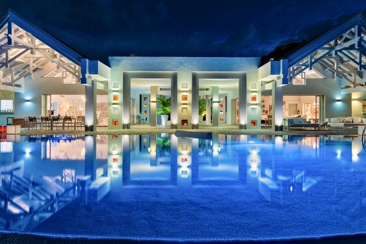 Baie Rouge villa Le Reve nighttime image of villa reflected in a pool