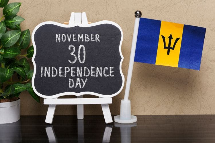 The Barbados falg next to a chalk board with the text 'November 30 Independence Day'