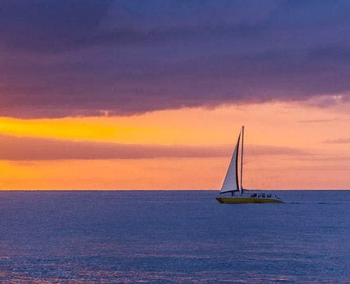 Sailboat on a calm sea at sunset