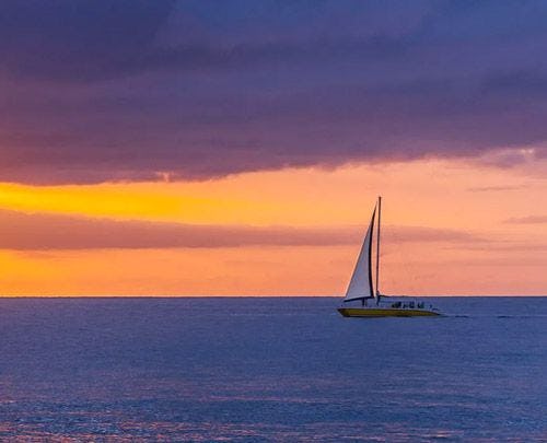 Sailboat on a calm sea at sunset