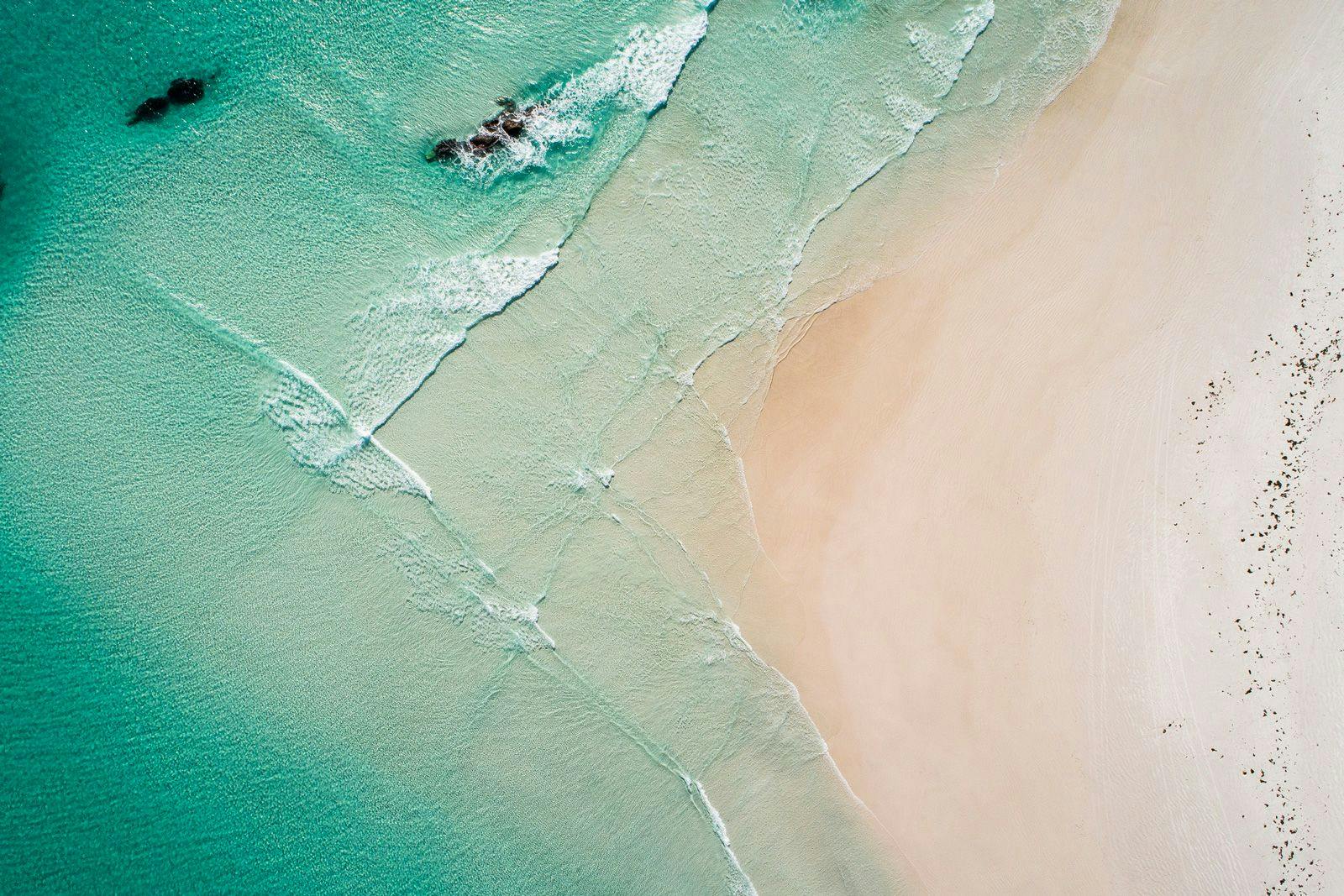 Ariel shot of a white sand beach and sea