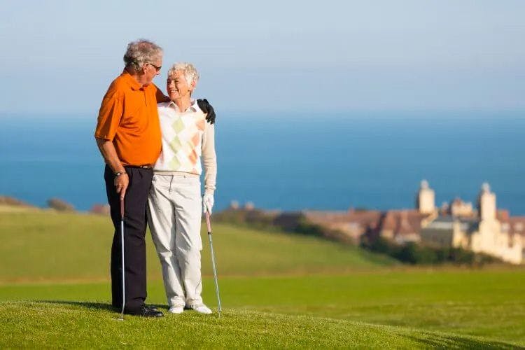 A couple standing on a golf course