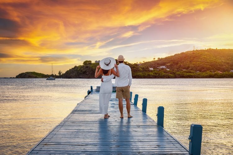 Best time to visit Antigua, sunset couple, shoulder season, Top Villas