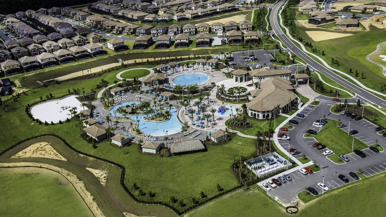 Aerial view of Championsgate Resort community pools, clubhouse, sports courts, and vacation rentals