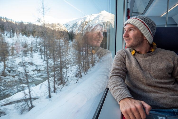 Closest ski resorts to the UK, train travel, man looking out of train window, Top Villas