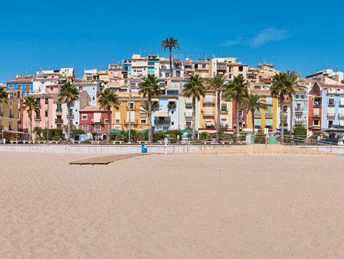 Vilajoyosa town on the Costa Blanca with colorful buildings on a golden sand beach