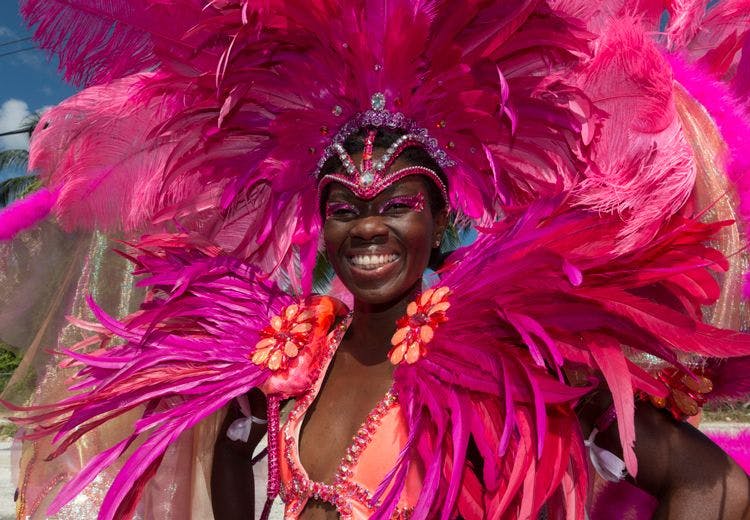 A lady in bright pink feathered festival costume