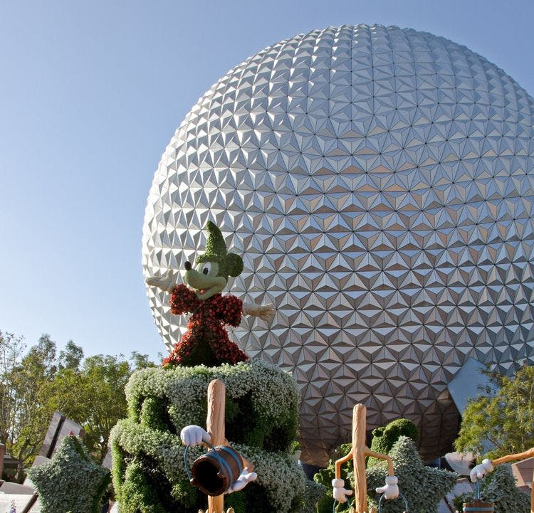 A plant-made Mickey Mouse in front of the Epcot ball at EPCOT International Flower & Garden Festival