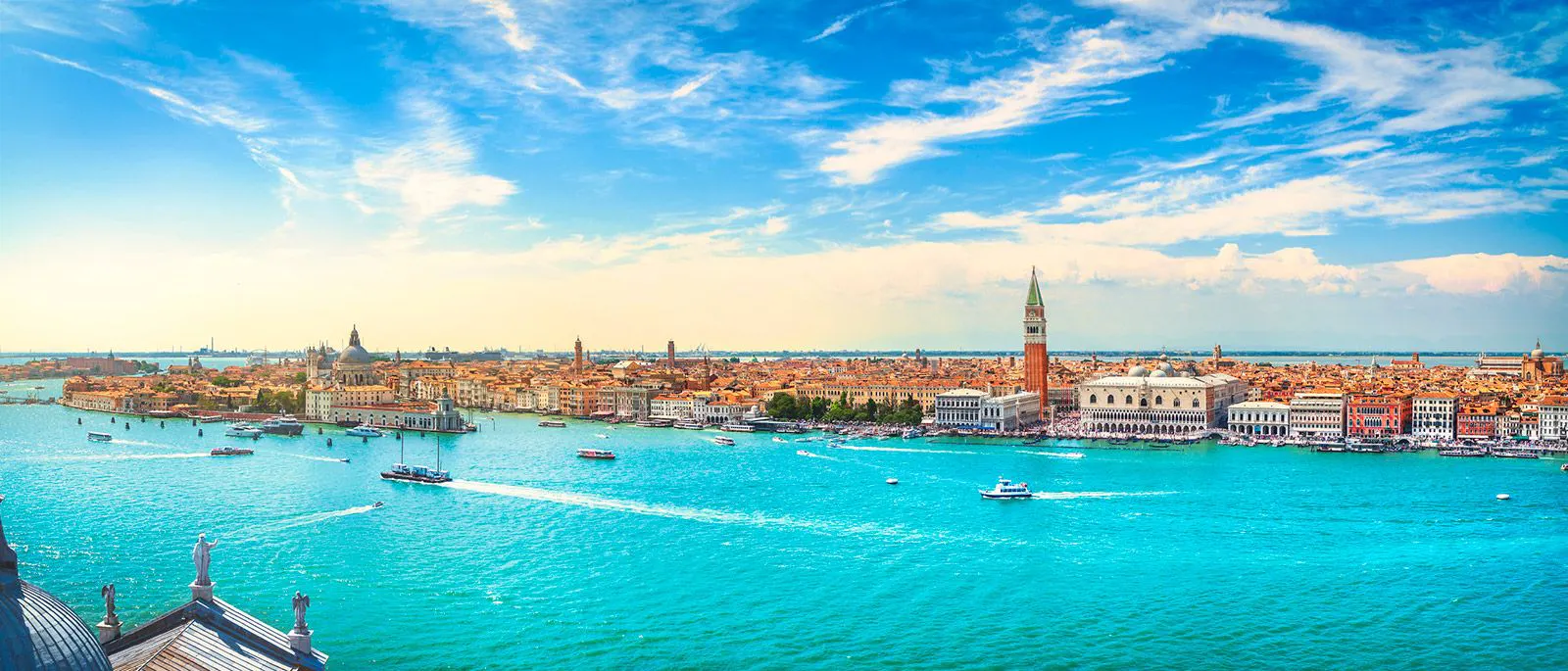 The lagoon in Venice with boats and a view of the city skyline