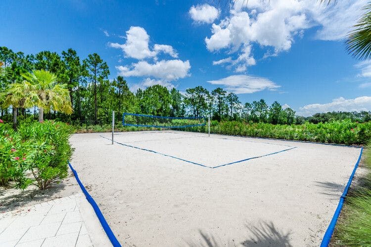 A sun-drenched sandy volleyball court at Festival Resort Orlando