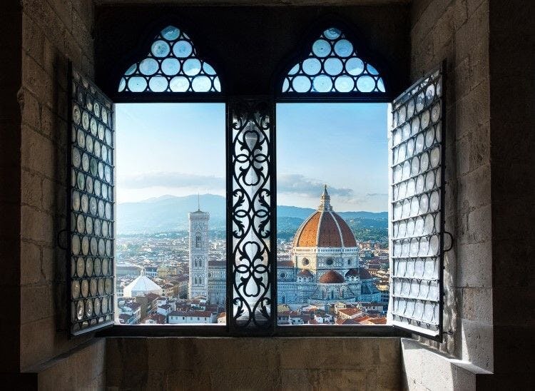 A view pf Florence Duomo through an ornate window
