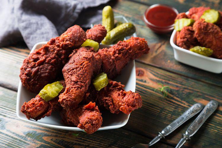 Tennessee hot chicken drumsticks on a white square plate