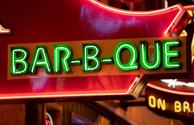 A neon BBQ restaurant sign