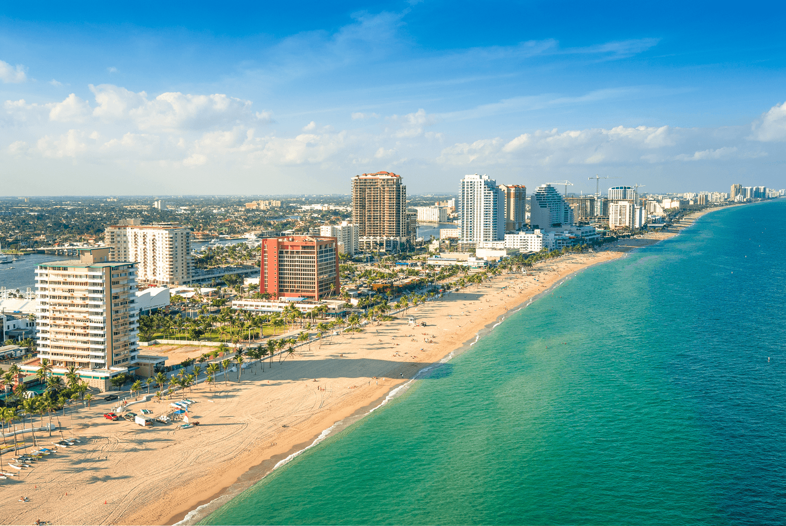 Aerial shot of Fort Lauderdale beach with tall buildings along the sand