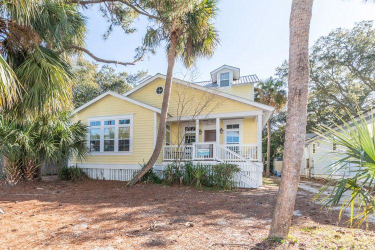 Tybee Island 72 yellow Georgia vacation rental with trees in the front garden