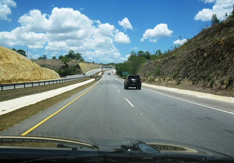 A view out of the windscreen of a car on a highway in the Dominican Republic