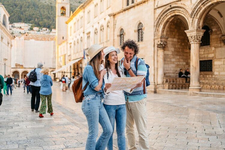 A group of friends explore Dubrovnik with a map