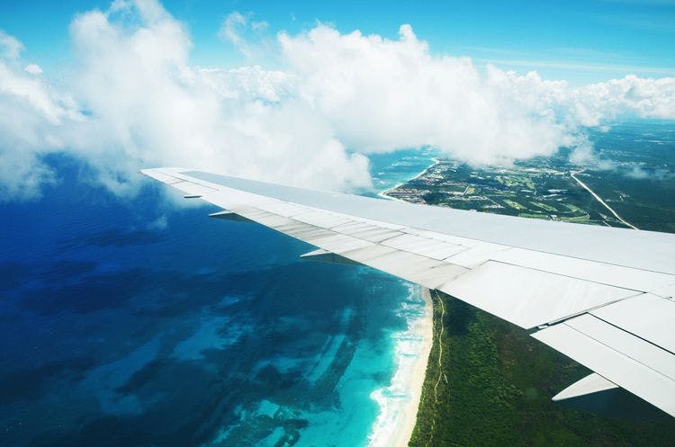 View from an airplane window of flying over the Caribbean