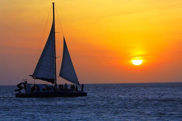 A private yacht takes in the sunset off the coast of Barbados