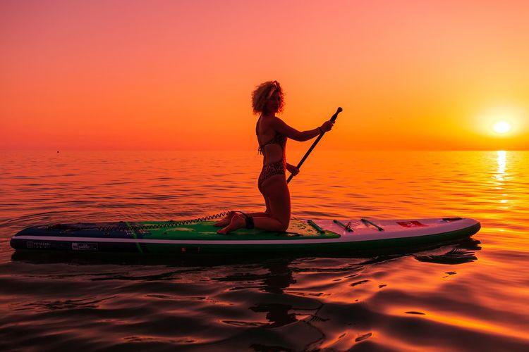 Ibiza paddleboarding at sunset