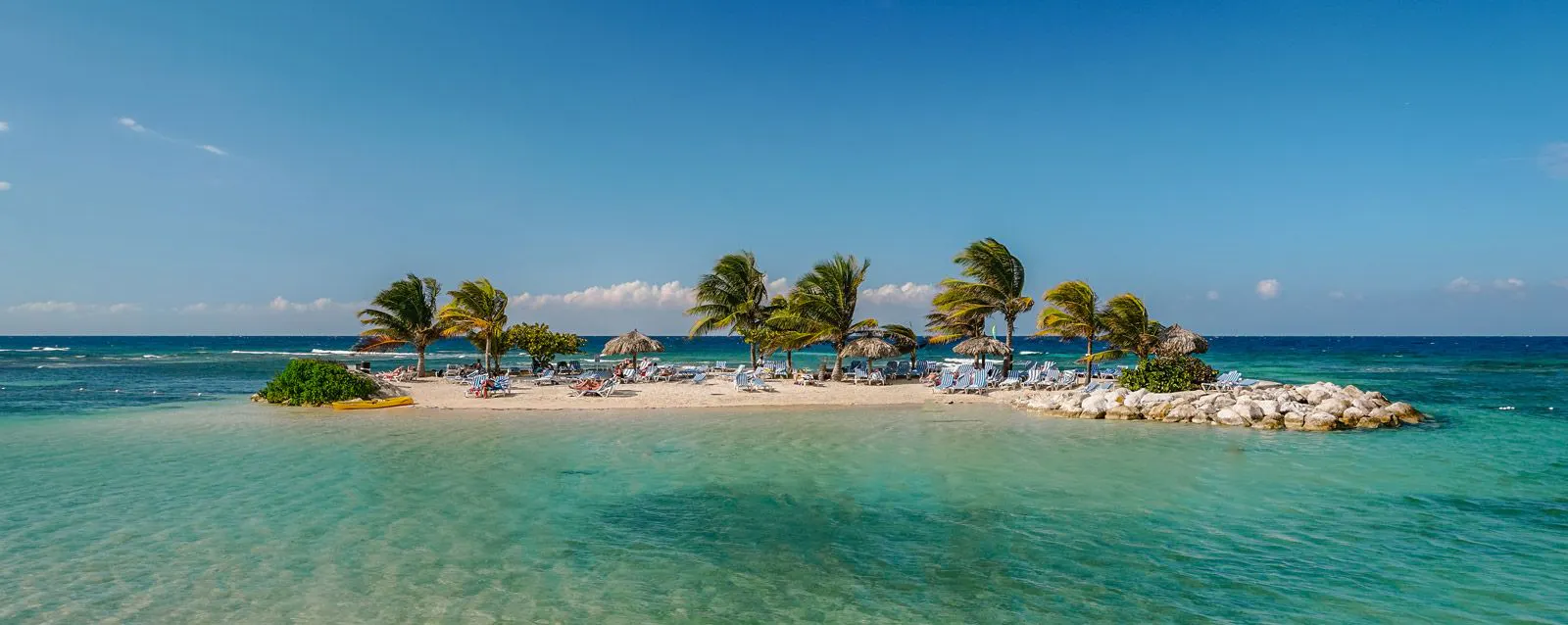 A white sand island with palm trees in Jamaica