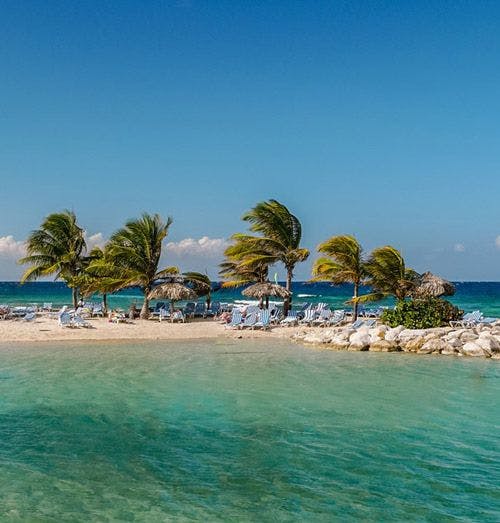 Tiny sandy island with palm trees in Jamaica