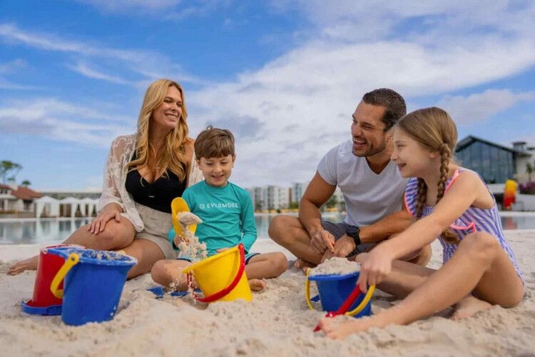 Evermore guests enjoy building sandcastles on the tropical beach of Evermore Bay, Orlando