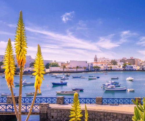 Lanzarote seafront town with small fishing boats in the harbor