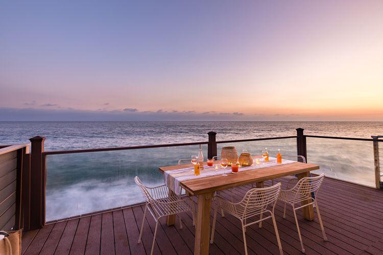 Malibu beach house rentals - Malibu 21 outside deck with table and chairs by the sea
