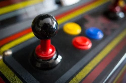 A close up shot of a joystick and buttons on a gaming machine