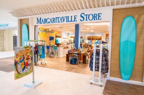 The front of Maragritaville Store with a surfboard outside