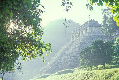 A view of a Mayan temple through the mist in Mexico