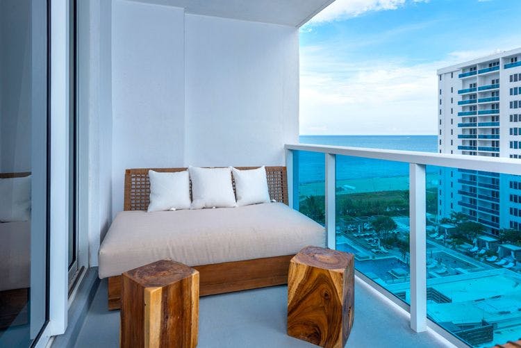 Miami vacation condo rentals Miami Beach 71 condo in high rise building with couch on balcony