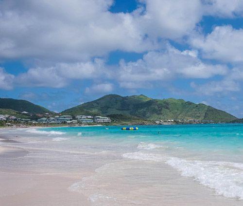 White sand beach and forested hills in Orient Bay