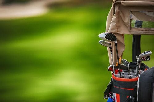 A golf caddy bag with clubs