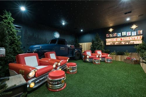 A private movie room decorated like a drive in theater in an Orlando villa