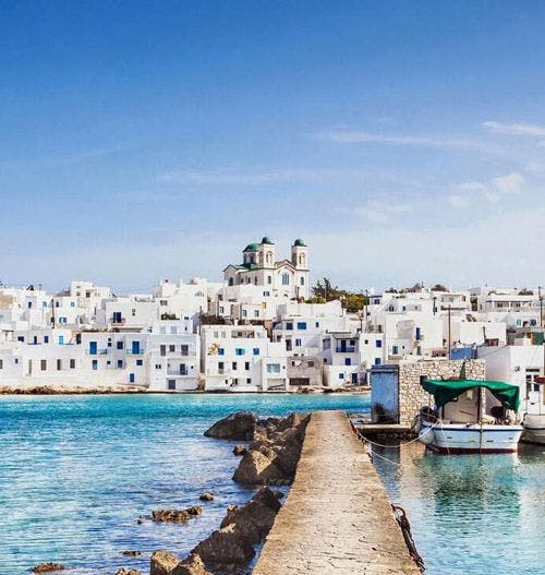 White sugar cube buildings by the sea in Paros