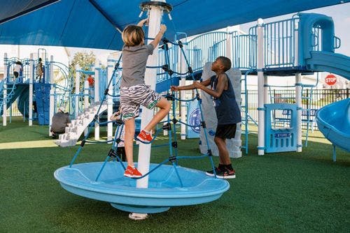 Children playing on climbing equipment at Solterra Resort play area