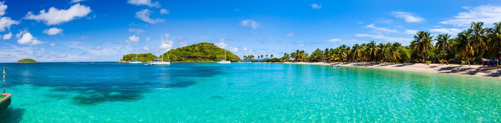 Saint Vincent and the Grenadines sheltered cove with white sand beach and reef