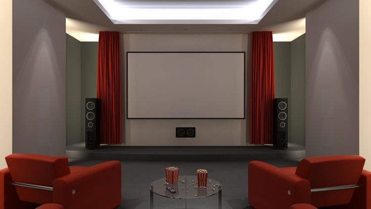 Stock image of home theater with red curtains across screen, chairs, and popcorn buckets