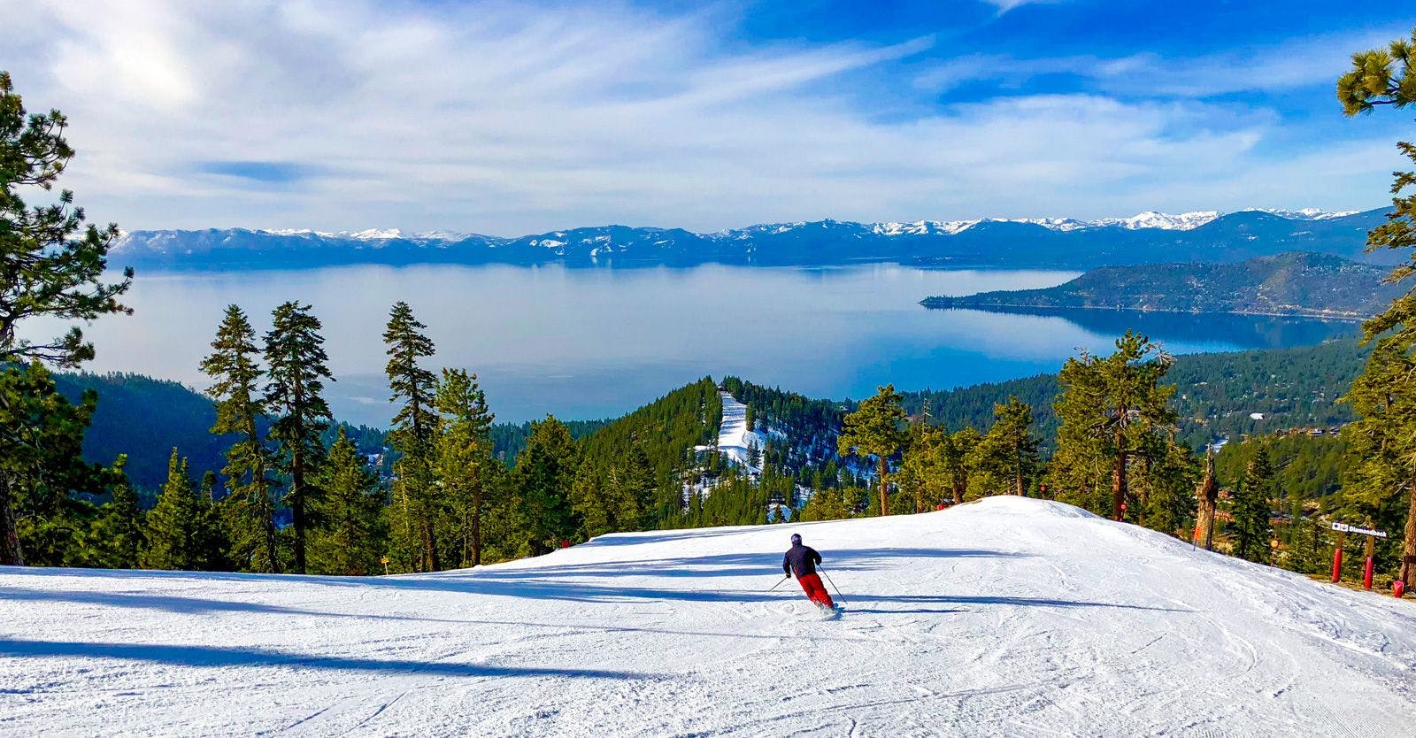Skiing vacation rentals. A person skiing down a run at Lake Tahoe