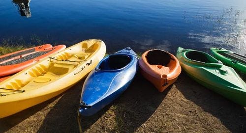 Colorful kayaks on the shore of a lake