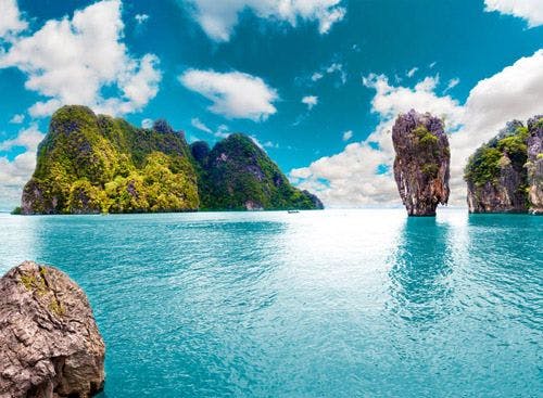 Limestone rock formations rising from the sea in Thailand